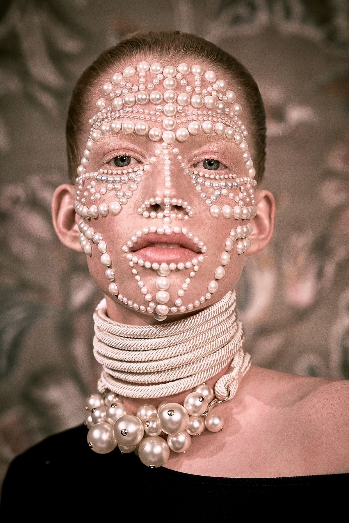 Image: Elizaveta Porodina photography project for Lotte//TextilWirtschaft showing the portrait of a model with buttons on her face to create a design, is an important example of her fashion and fine art photography